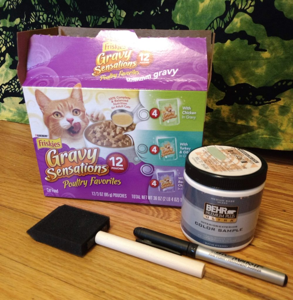 Friskies box with paint and paintbrush
